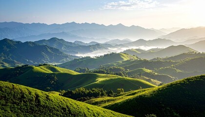 Fototapeta premium Green rolling hills under misty mountains