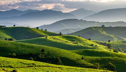 Obraz premium Green rolling hills under misty mountains