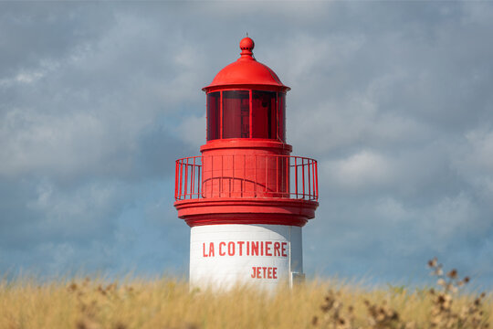 La Cotinière Lighthouse on a sunny day in summer. Beautiful red and white french lighthouse located in La Cotinière, Oléron island, Charente-Martime in France. - Powered by Adobe