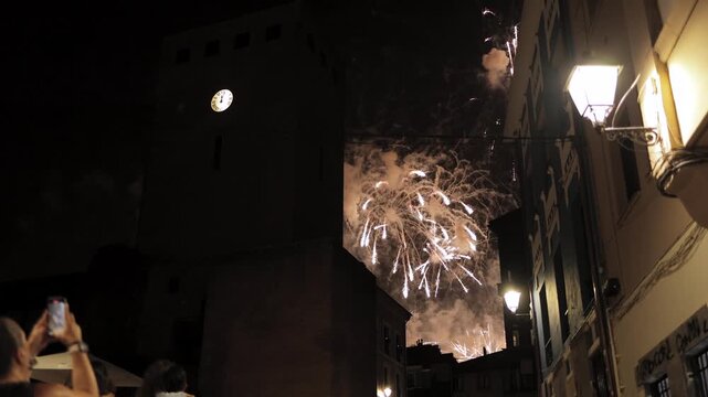 Fireworks exploding in the night sky above an old clock tower, New Year&rsquo;s Eve celebration, holiday, tradition, magic, history, architecture, light, joy, wonder, beauty, atmosphere, festival, countdown