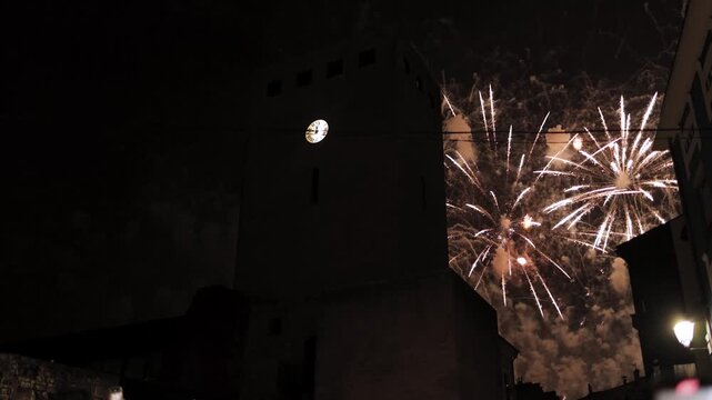 Christmas fireworks exploding in the night sky above an old clock tower, New Year&rsquo;s Eve celebration, holiday, tradition, magic, history, architecture, light, joy, wonder, beauty, atmosphere, festival
