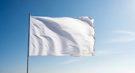 Blank white flag waving against a blue sky.