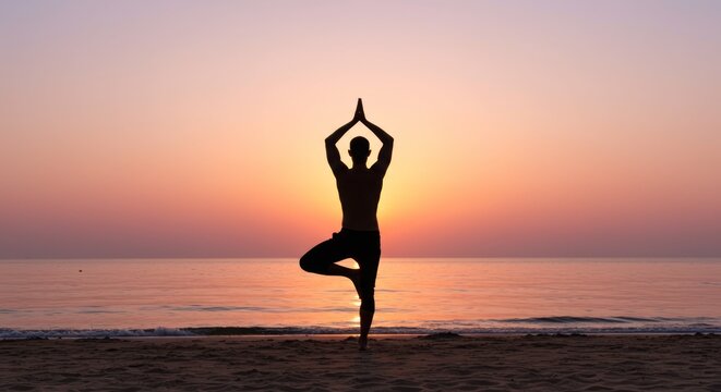 Man practices yoga pose at sunset on the beach for relaxation - Powered by Adobe