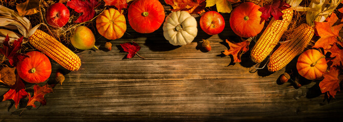 Festive autumn composition from pumpkins and colorful leaves on a dark wooden background. Thanksgiving day.