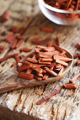 Pieces of red sandalwood on a wooden spoon