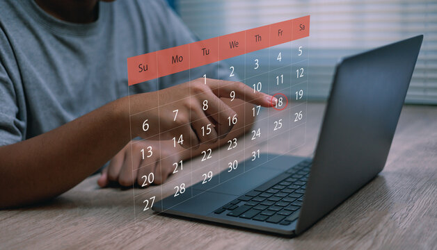 Man pointing at digital calendar on laptop screen,Concepts of online scheduling event planning ,time management and digital productivity tools - Powered by Adobe