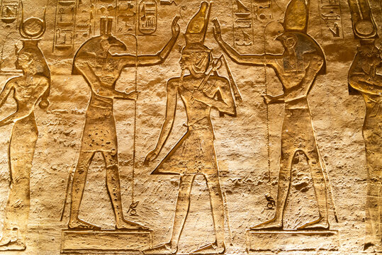 Symbolic scene represented on a wall in the interior of a temple in the archeological site named "Abu Simbel", Egypt, with the representation of pharaoh Ramesses between gods "Horus" and "Thot".