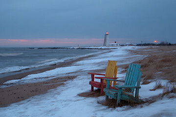 Winter Beach Scene with Adirondack Chairs and Lighthouse