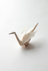 A single origami crane folded from textured paper, representing peace, mindfulness, and Japanese tradition.