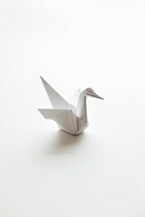 A single origami crane folded from textured paper, representing peace, mindfulness, and Japanese tradition.