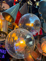 Vintage lamps and chandeliers with warm glowing bulbs. Retro design, nostalgia, and cozy ambiance.
