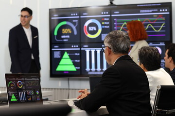 Diverse Team Working Together in Modern Co-Working Space. Casual meeting of senior diverse business team analyzing financial data. Multiethnic business people working in the office. senior man.