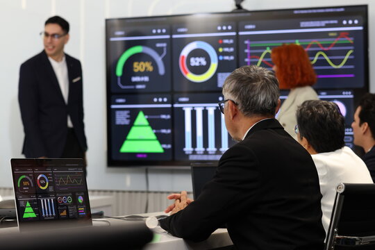 Diverse Team Working Together in Modern Co-Working Space. Casual meeting of senior diverse business team analyzing financial data. Multiethnic business people working in the office. senior man.