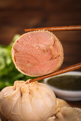 Fresh Sliced Pork Belly with Steamed Buns and Chopsticks for Traditional Asian Meal