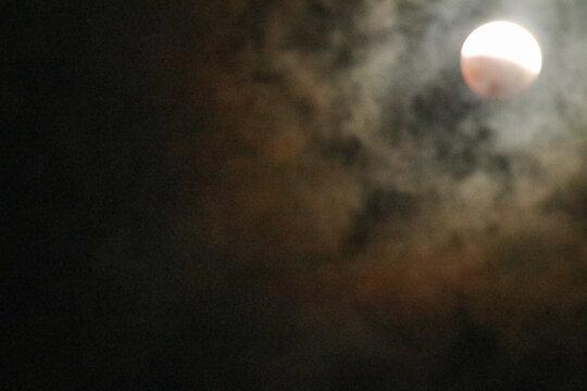 A beautiful rare blood moon on a dark night sky - Powered by Adobe