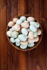 Fresh Free-Range Farm Eggs in Wicker Basket on Rustic Wood Background
