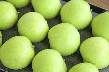 Fresh Green Pears Display on Dark Tray - Organic Fruit Collection