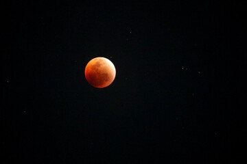 A beautiful rare blood moon on a dark night sky