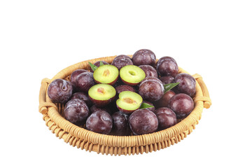 Fresh Sweet Plums in Wicker Basket with Cut Halves Showing Green Flesh on White Background