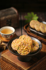 Spiced Nutty Grain Pastries with Purple Sesame Seeds and Tea - Traditional Asian Shortcake Dessert