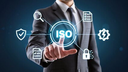 Business professional in suit interacting with digital icons representing ISO standards, security, and documentation, conveying sense of innovation and technology