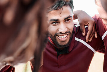 Sports, huddle and rugby team on a field planning a strategy for a game, match or tournament. Fitness, diversity and man captain talking to group at training, exercise or practice on an outdoor pitch