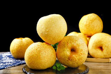 Fresh Yellow Asian Pears on Wood Surface with Black Background - Organic Fruit Display