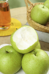 Fresh Green Apples Cut Open on Rustic Wood Kitchen Counter with Natural Honey and Wicker Basket