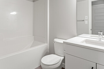 Bathroom with a white toilet and bathtub