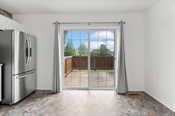 Kitchen with a silver refrigerator and a white door