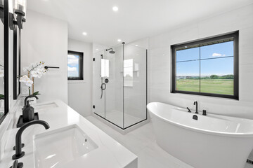 Large white bathroom with a bathtub and sink