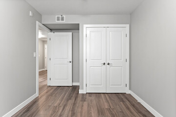 White room with a door leading to another room
