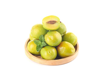 Fresh Green Plums in Wooden Bowl with Mint Leaf on White Background
