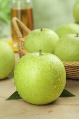 Fresh Green Apples with Water Drops in Rustic Wicker Basket - Healthy Organic Fruit Still Life