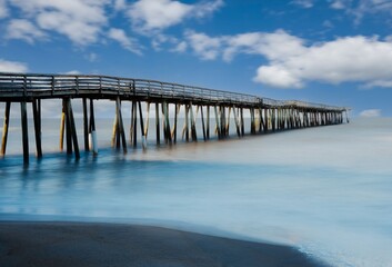 Serene Coastal Pier Under Blue Sky