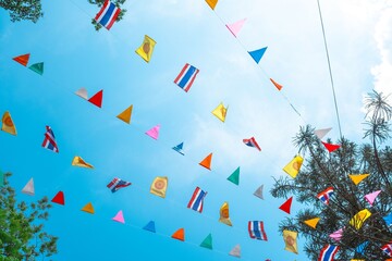 Festive colorful flags against a blue sky.