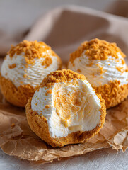 Delicious Cream Puffs with Crumbled Topping A Tempting Sweet Treat Displayed on Textured Background Paper Revealing Decadent Filling