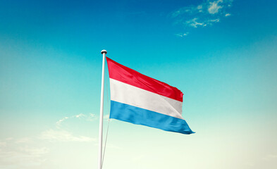 Luxembourg national flag waving in beautiful sky with mast. A proud moment flag waving with sunlight.