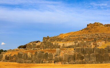 Saqsaywaman, an ancient Inca site in Cusco, Peru, with massive stone walls under a clear blue sky.