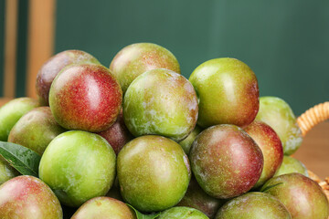 Fresh Organic Plums in Wicker Basket - Sweet and Crisp Stone Fruit Display