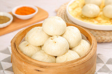 Fresh Xiaolongbao Chinese Soup Dumplings in Bamboo Steamer with Dipping Sauces