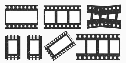 Collection of distressed black film strips and frames with empty white spaces for images or text