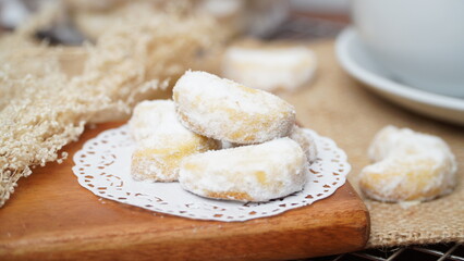 Homemade Putri Salju cookies coated in powdered sugar, and with hot black coffee. Perfect for festive food promotions and design assets