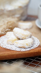 Homemade Putri Salju cookies coated in powdered sugar, and with hot black coffee. Perfect for festive food promotions and design assets