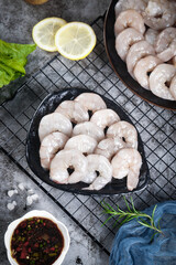 Fototapeta premium Fresh Raw Shrimp with Lemon and Herbs Ready for Cooking