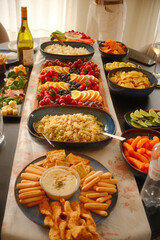 Bright Party Table with Dips, Snacks, Fruits, and Pasta Salad