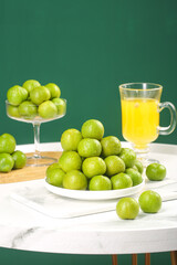 Fresh Sichuan Plums with Golden Juice Still Life on Marble Table
