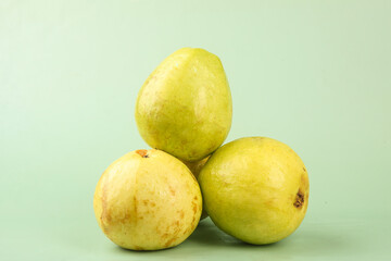 Fresh Ripe Guava Fruits with Soft Creamy Skin on Green Background - Tropical Exotic Healthy Food