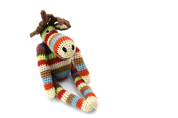 Handmade knitted plush toy in the shape of a moose, photographed on a clean white background