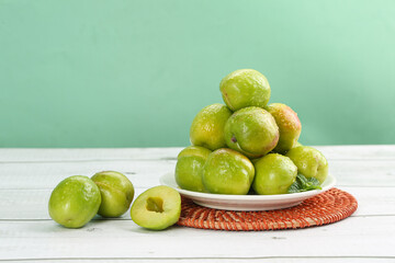 Fresh Green Xinjiang Apricots on White Plate - Organic Stone Fruit Display